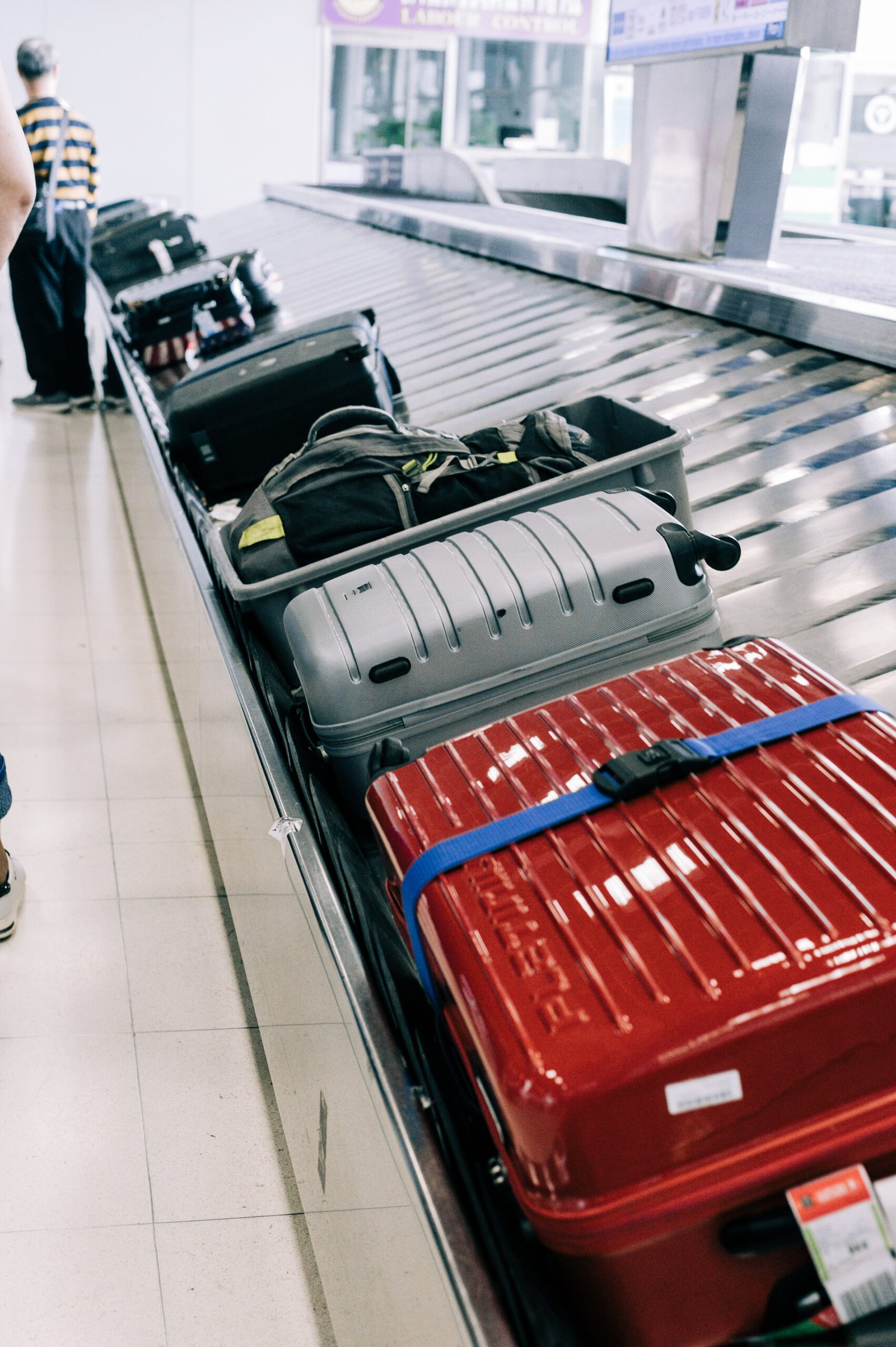 high-angle-view-luggage-conveyor-belt-airport Suitcase or baggage on luggage conveyor belt in an arrivals lounge of airport terminal.